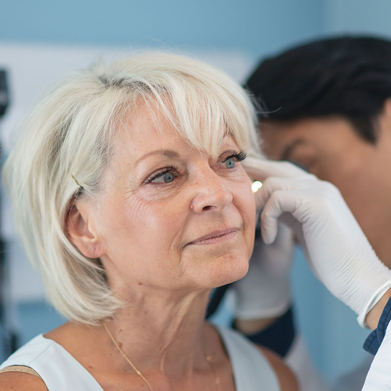 Woman having her ears examined by a doctor to check for causes of hearing loss. 