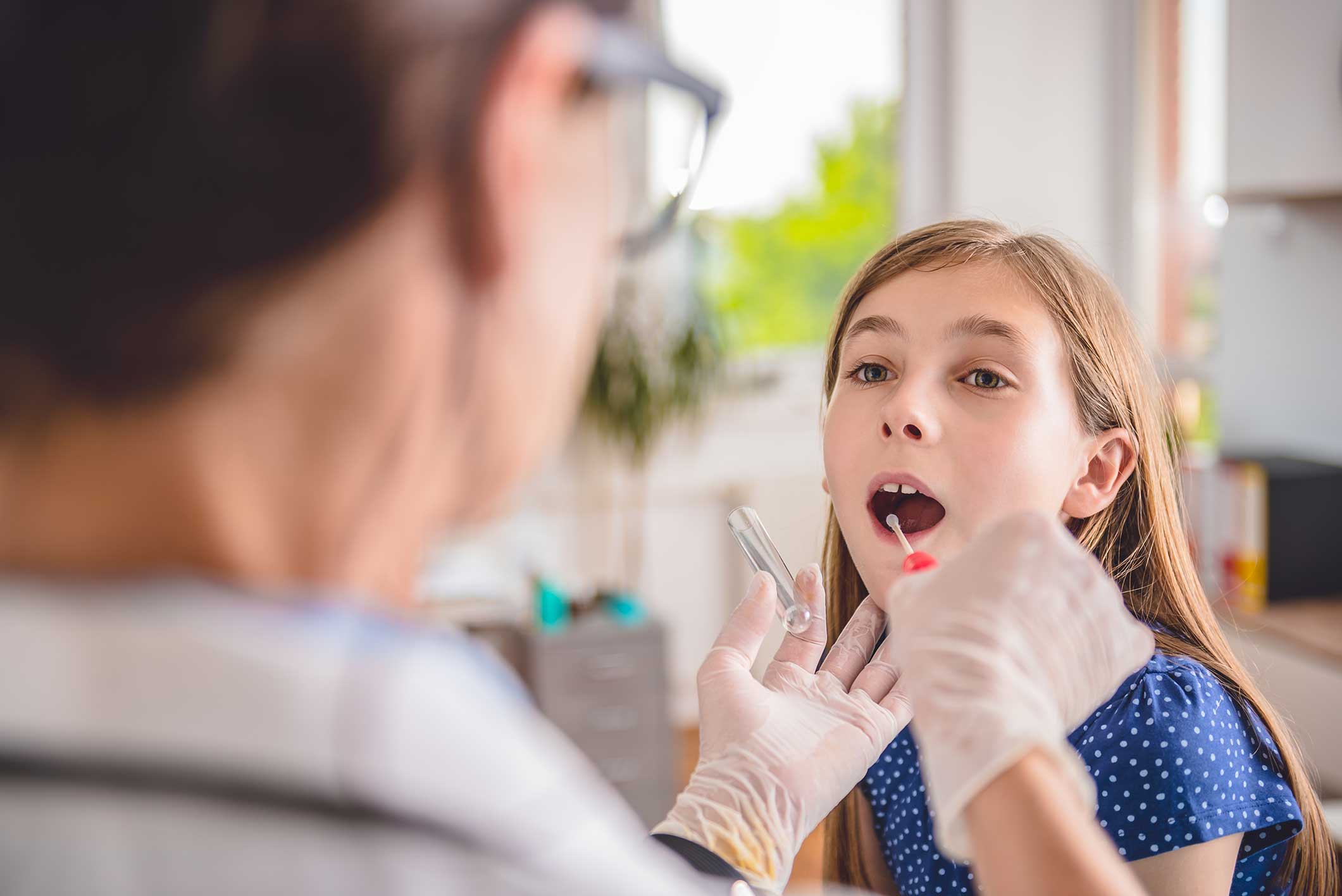 ENT taking a sample from a patient's mouth