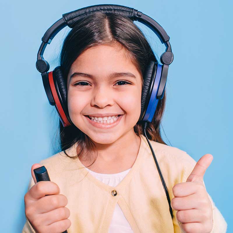 Young girl wearing headphones for her hearing test