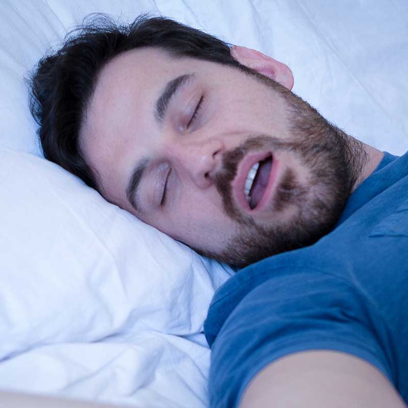 Man snoring in his sleep because of his adenoids