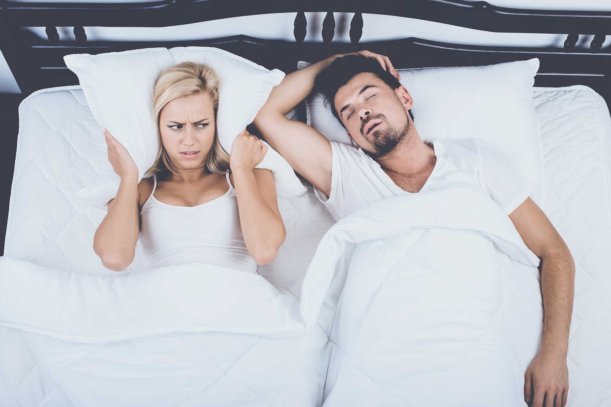 Woman being bothered by her husband's sleep apnea