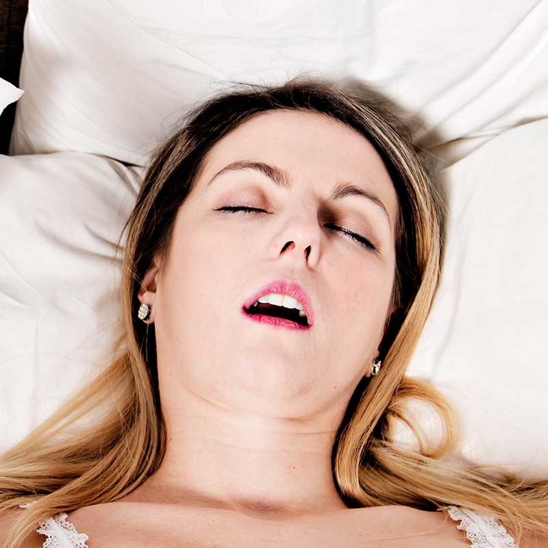 Woman snoring with her mouth wide open.