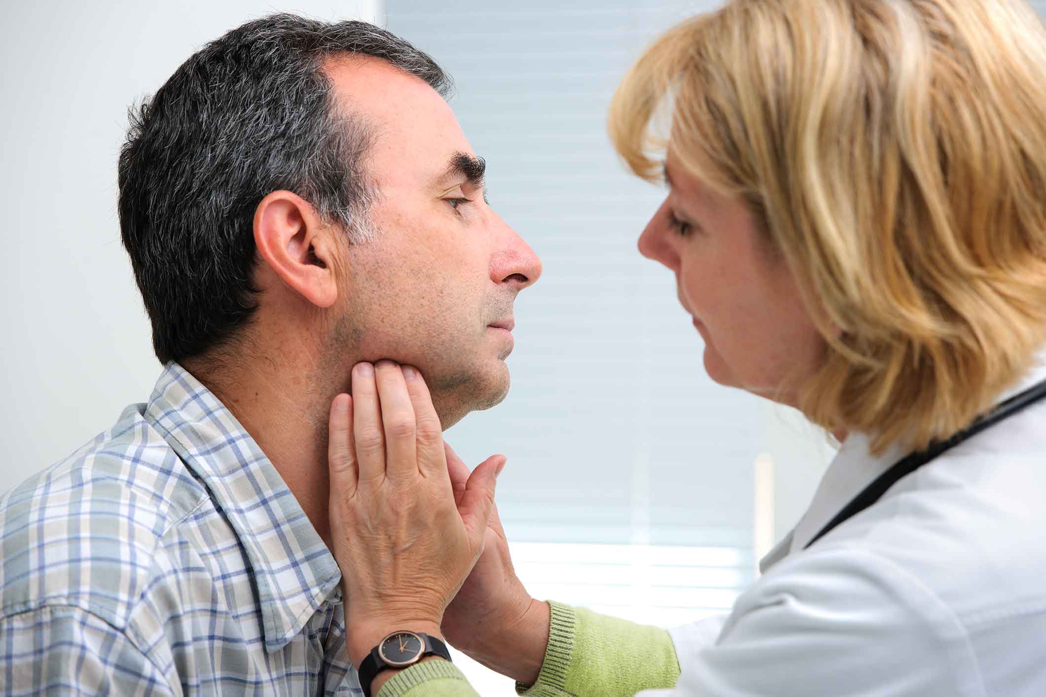 Doctor examining a patients throat