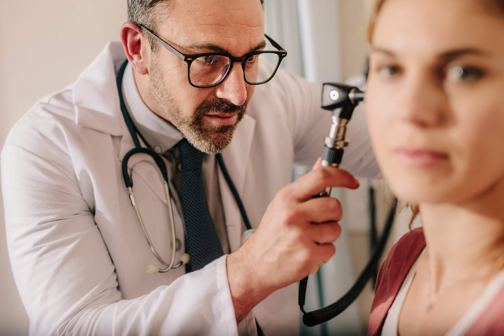 Doctor examining a woman's ear