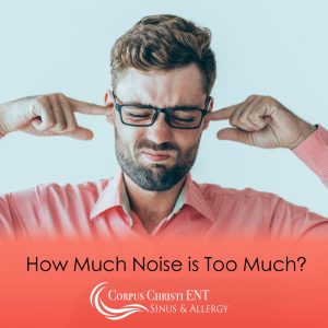 Man plugging his ears to mute noise
