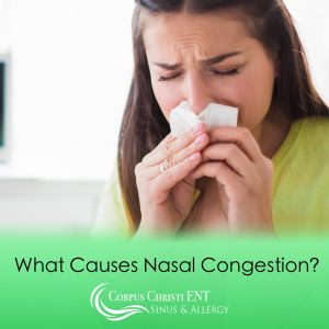 Woman blowing her nose because of nasal congestion